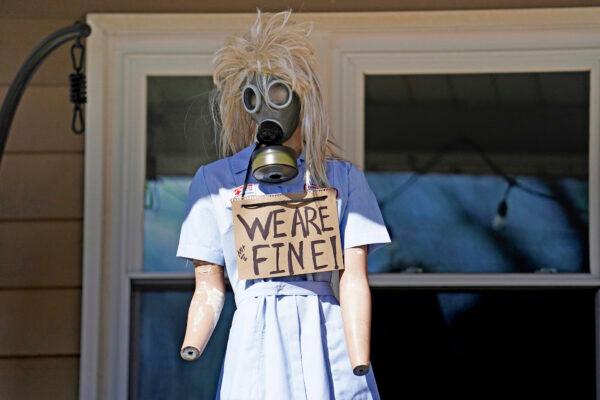 A resident displays a mannequin on their porch in East Palestine, Ohio, as cleanup from the Feb. 3 Norfolk Southern train derailment continues, on Feb. 24, 2023. (Matt Freed/AP Photo)
