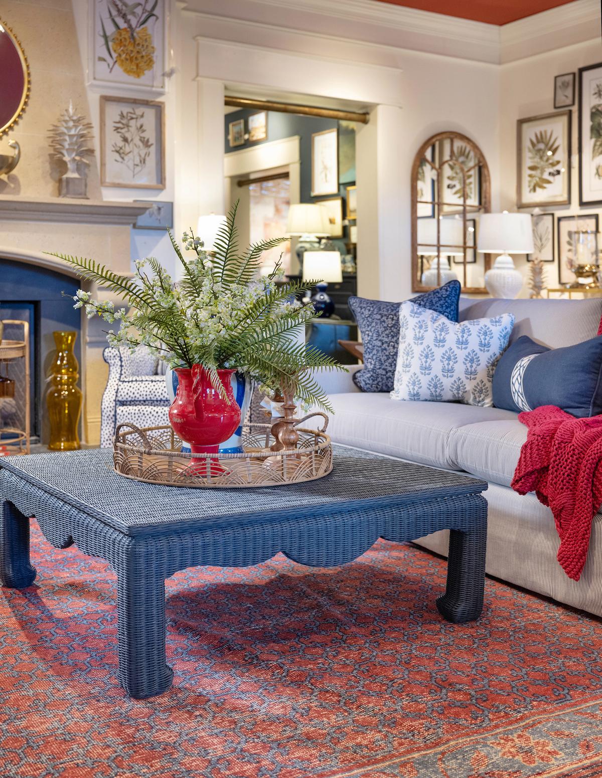 A wicker coffee table is reimagined with a scrolled silhouette and deep blue color. (Handout/TNS)