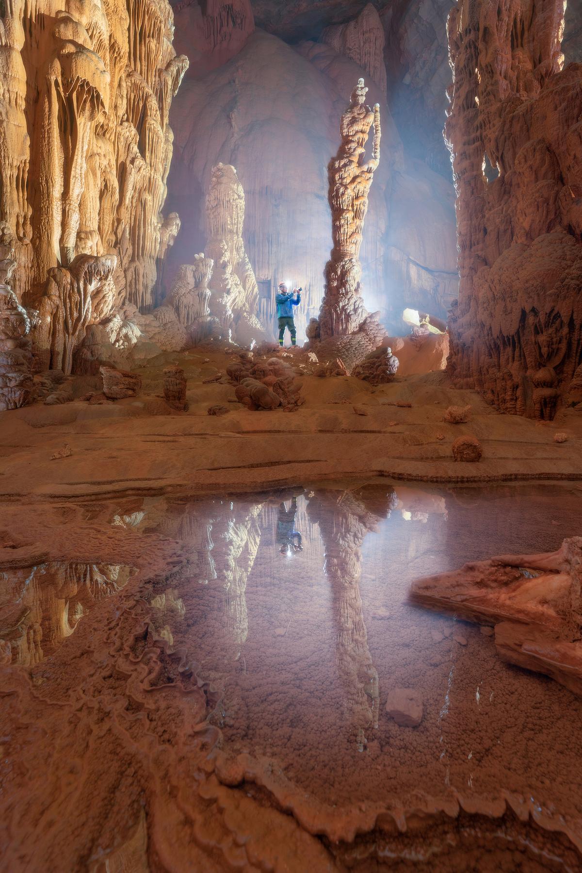 An explorer photographs inside Hung Cave. (Courtesy of Cao Ky Nhan via Jungle Boss Tours)