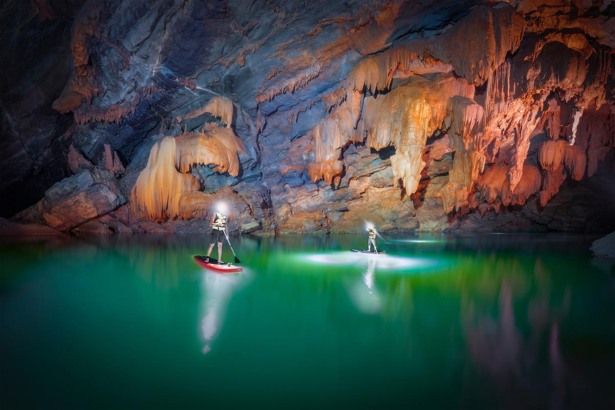 Paddleboarders inside Tron Cave. (Courtesy of Cao Ky Nhan via Jungle Boss Tours)
