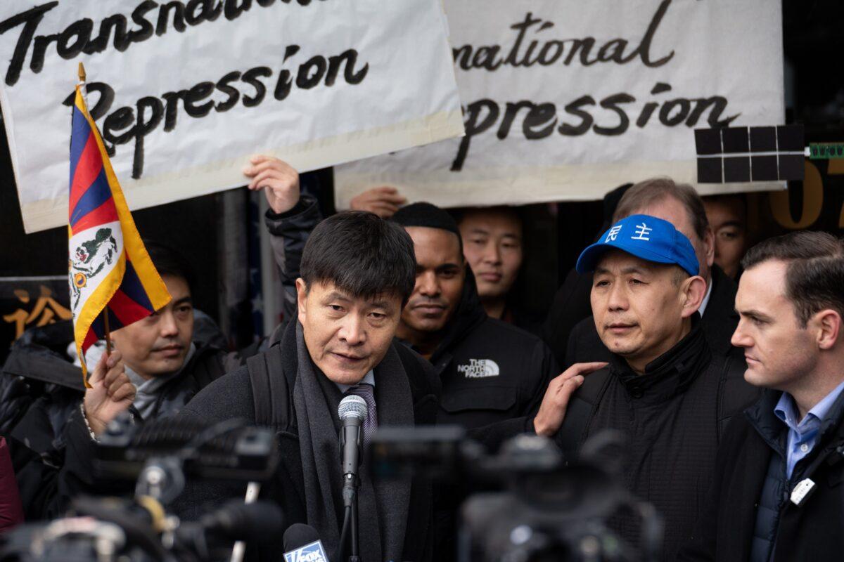 Zhou Fengsuo (L), human rights activist former student leader during the Tiananmen Square protests of 1989, introduces Chinese dissident Wang Yonghong at a press conference and rally in front of the America ChangLe Association highlighting Beijing's transnational repression, in New York City on Feb. 25, 2023. A now-closed overseas Chinese police station is located inside the association building. (Samira Bouaou/The Epoch Times)