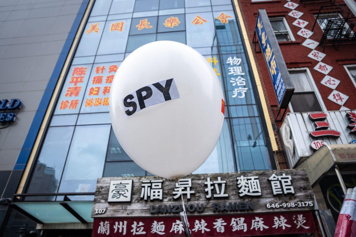 A balloon is held at a press conference and rally in front of the America ChangLe Association highlighting Beijing's transnational repression, in New York City on Feb. 25, 2023. A now-closed overseas Chinese police station is located inside the association building. (Samira Bouaou/The Epoch Times)