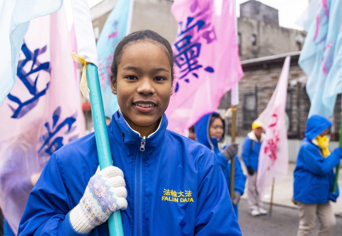 Falun Gong practitioner Karla Wilson Young walks in a parade in Brooklyn, N.Y., highlighting the Chinese regime's persecution of their faith on Feb. 26, 2023. (Chung I Ho/The Epoch Times)