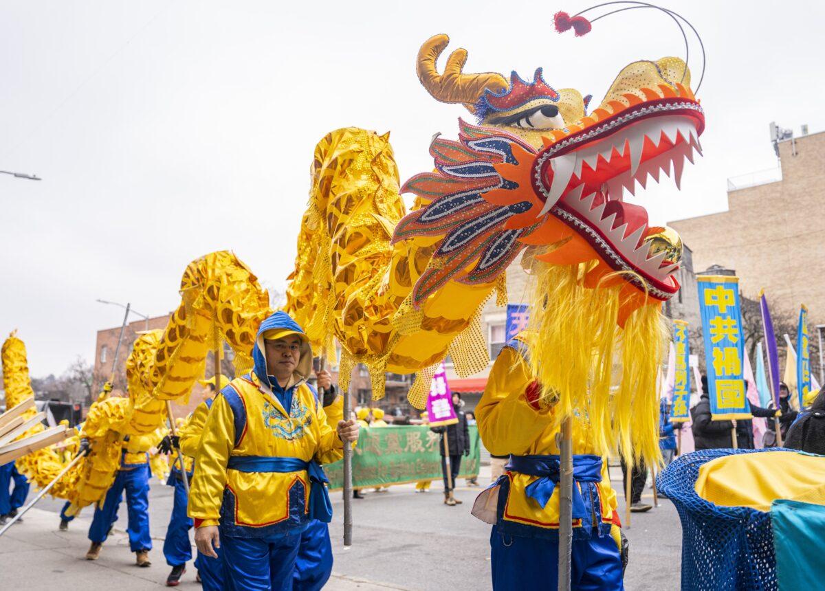Falun Gong practitioners walk in a parade in Brooklyn, N.Y., highlighting the Chinese regime's persecution of their faith on Feb. 26, 2023. (Chung I Ho/The Epoch Times)
