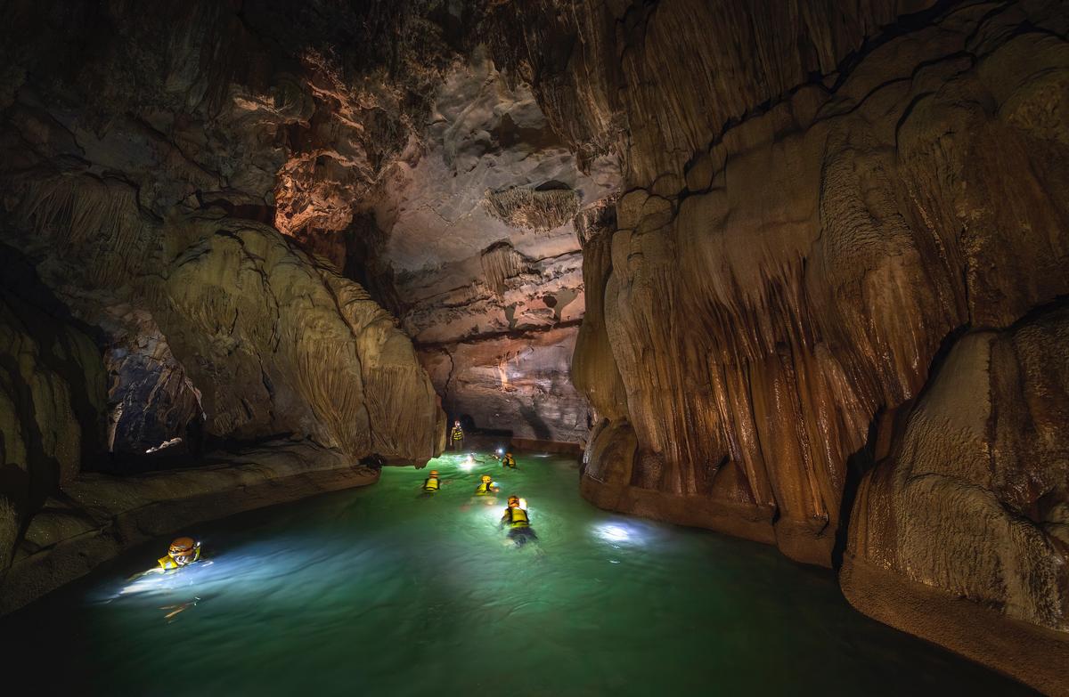 Adventurers swim inside Thung Cave. (Courtesy of Nguyen Hai via Jungle Boss Tours)