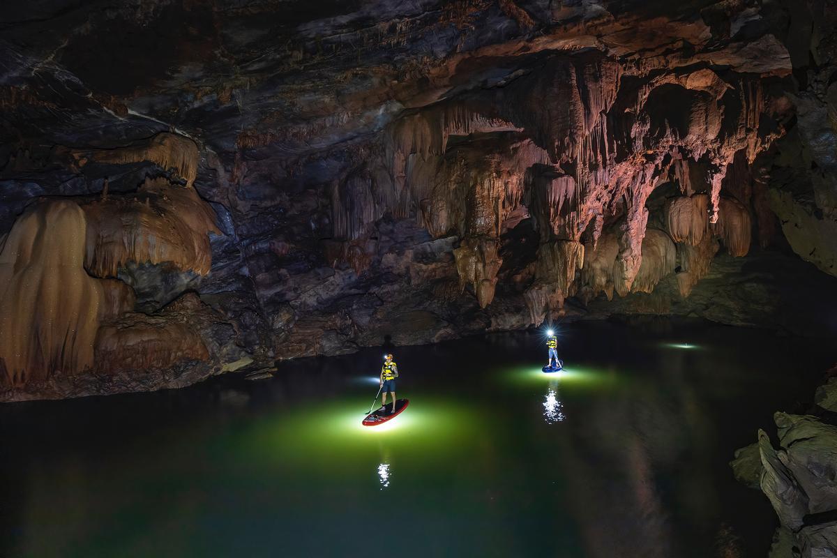 Paddleboarders explore Tron Cave. (Courtesy of Nguyen Hai via Jungle Boss Tours)