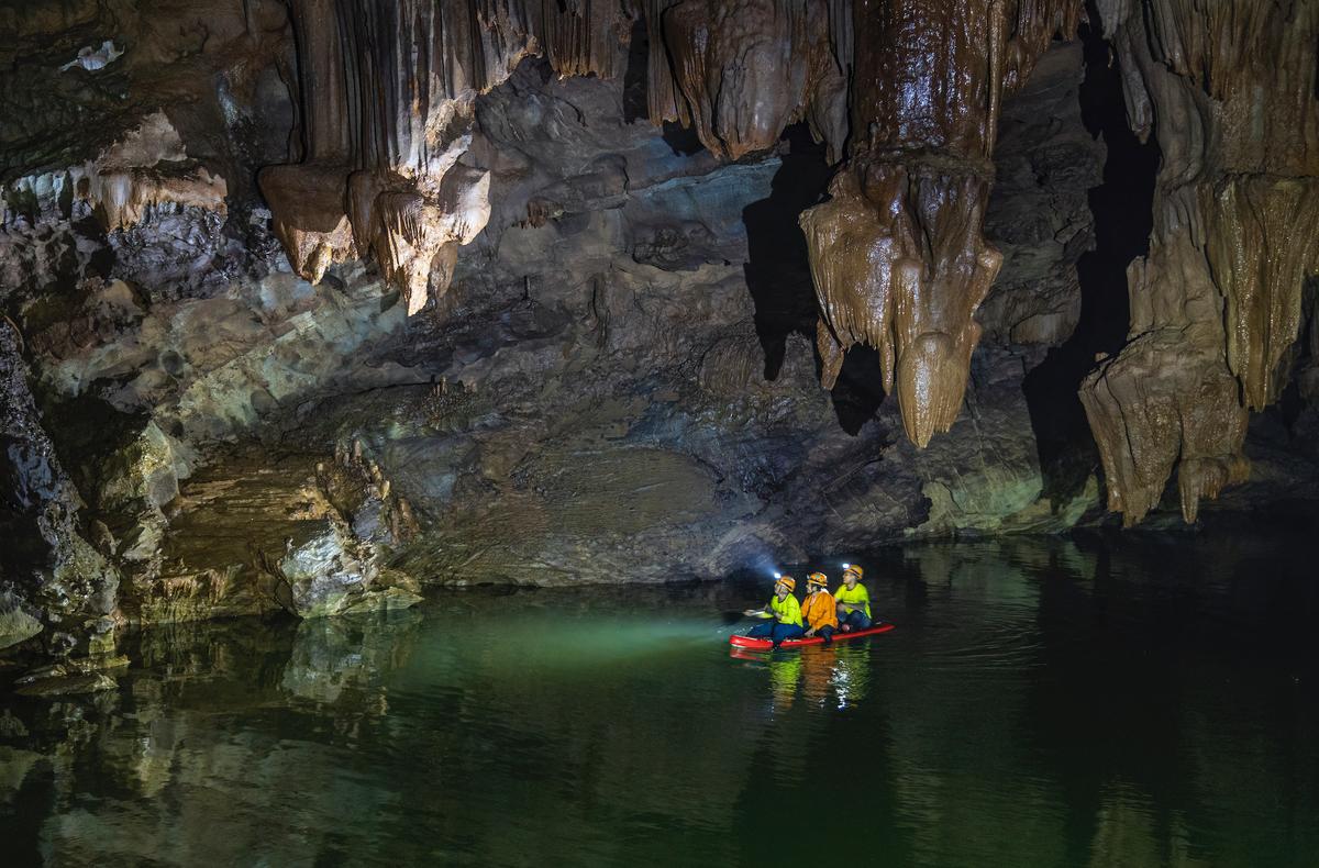Boaters inside Tron Cave. (Courtesy of Nguyen Hai via Jungle Boss Tours)