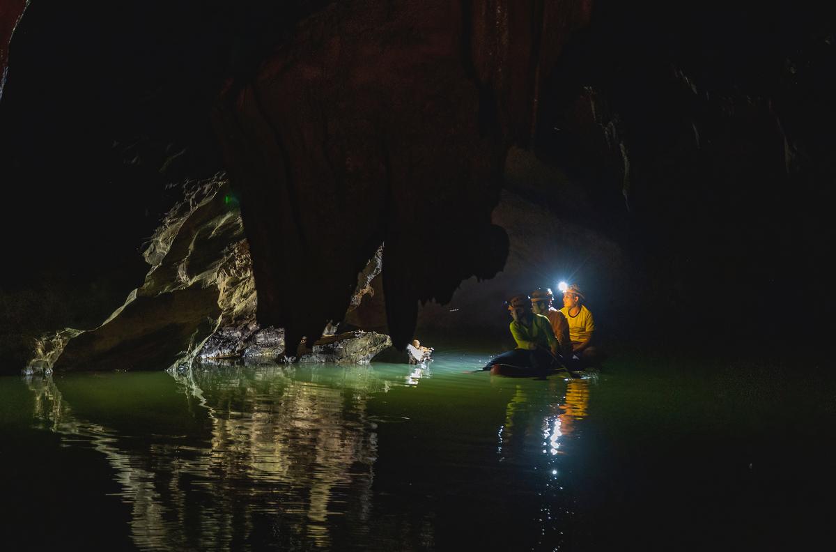 Boaters amid geological wonders inside Tron Cave. (Courtesy of Nguyen Hai via Jungle Boss Tours)