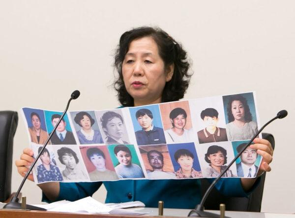 Wang Chunyan, a Chinese refugee currently living in Virginia, shows photos, of 16 friends who practiced Falun Gong and died of persecution in China, at a forum in the Rayburn Congressional Building in Washington on May 26, 2016. (Lisa Fan/The Epoch Times)