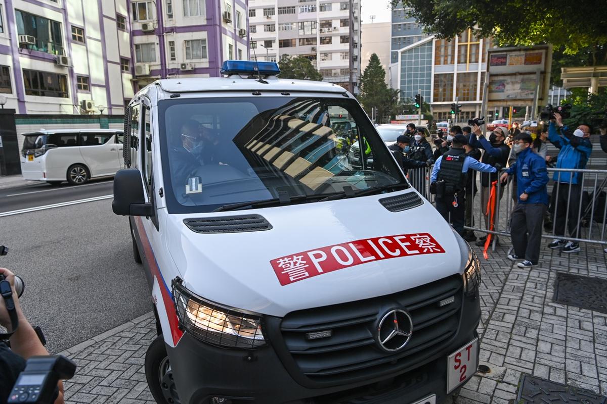 Socialite Abby Choi Tin-fung, 28 years old, was murdered and dismembered. Four suspects, three men and one woman, were escorted by police to the Kowloon City Court on Feb. 27. Suspects, with black hoods over their heads, were escorted to court by police vehicles. (Big Mack/The Epoch Times)