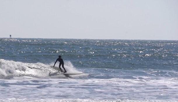Carter Doorley is surfing at the beach in Brigantine, NJ on Feb 26, 2023. (William Huang/The Epoch Times)