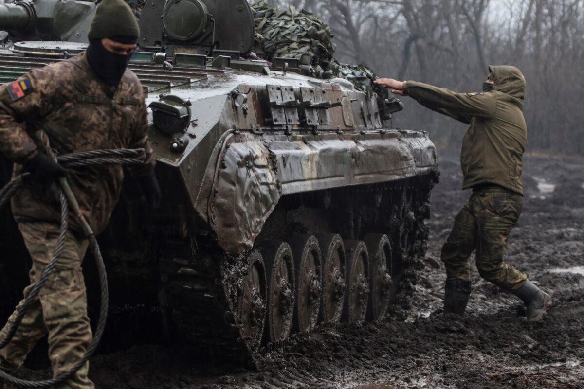 Ukrainian service members next an infantry fighting vehicle near the frontline town of Bakhmut, amid Russia's attack on Ukraine, in Donetsk region, Ukraine, on Feb. 25, 2023. (Yan Dobronosov/Reuters)