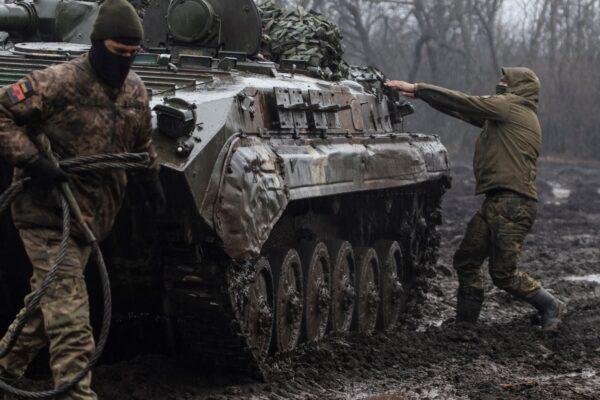 Ukrainian service members next to an infantry fighting vehicle near the frontline town of Bakhmut, amid Russia's attack on Ukraine, in Donetsk region, Ukraine, on Feb. 25, 2023. (Yan Dobronosov/Reuters)