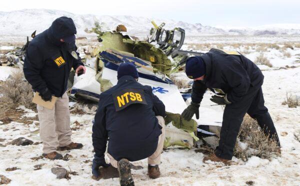 NTSB investigators document the wreckage of a Pilatus PC-12 airplane at the crash site in Dayton, Nev., on Feb. 26, 2023. (NTSB via AP)