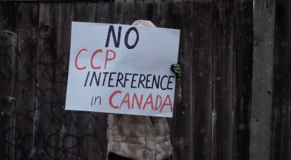 A protester holds a sign that reads "No CCP interference in Canada" at a rally outside of the Wenzhou Friendship Society in Richmond, B.C., on Feb. 25, 2023. (Vivian Yu/NTD)