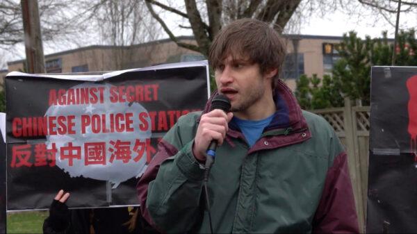 Andrew Wagner of the HK Defense Initiative speaks at a rally outside of a building that serves as the headquarters of the Wenzhou Friendship Society in Richmond, B.C., on Feb. 25, 2023. The protest was held to raise concerns about Chinese interference in Canada following media reports of an RCMP investigation at the building. (Vivian Yu/NTD)