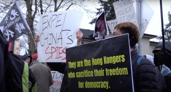 Protesters at a rally outside of the Wenzhou Friendship Society in Richmond, B.C., on Feb. 25, 2023, were seen holding signs that read "Expel China's Spies" among other slogans. (Vivian Yu/NTD)