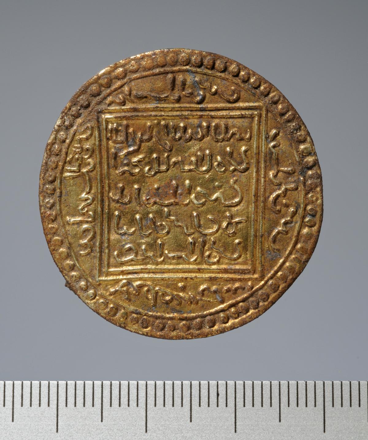 A gilded faux coin brooch, crafted to imitate an Islamic Almohad gold dinar coin, now reworked into a garment clasp in the Scandinavian tradition. (Courtesy of <a href="http://www.schleswig-holstein.de/">ALSH</a>)