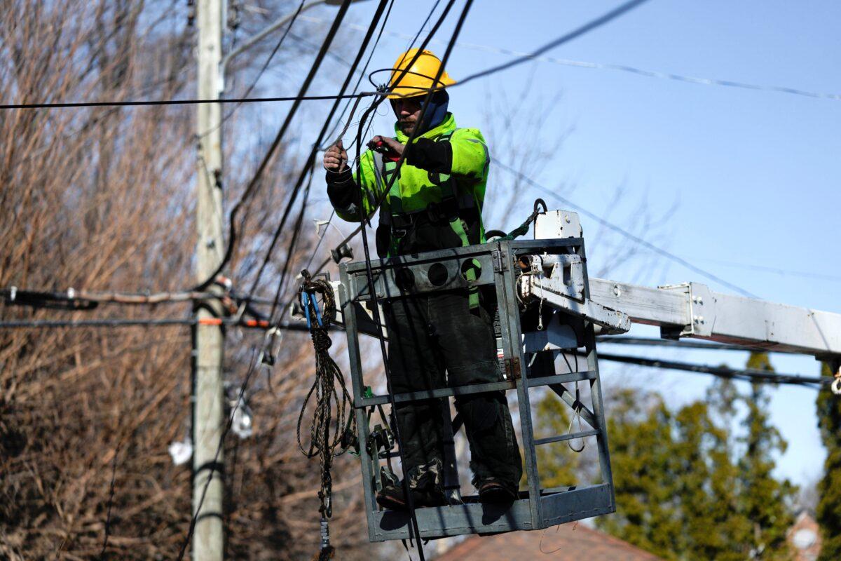 A utility worker works on lines in Detroit on Feb. 28, 2023. (Paul Sancya/AP Photo)