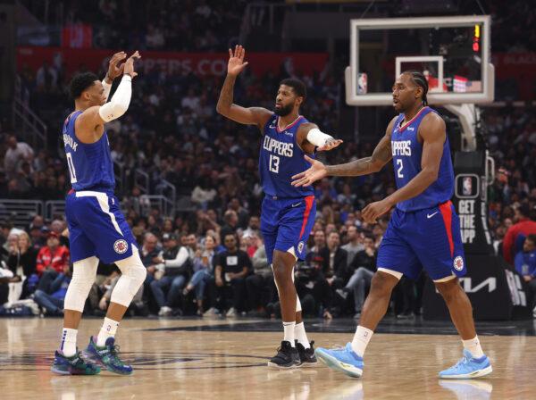 Kawhi Leonard (2), Paul George (13) and Russell Westbrook (0) of the LA Clippers celebrate after a timeout during the first half against the Minnesota Timberwolves in Los Angeles on Feb. 28, 2023. (Harry How/Getty Images)