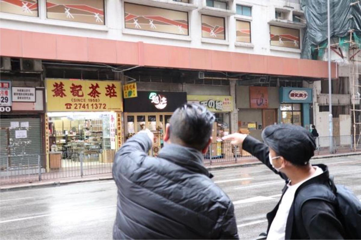 Chan King-lun (Right) visits various districts in Hong Kong to look for the “Northern Wei Style” fonts. The photo was taken on the street of Cheung Shan Wan in Hong Kong on Feb. 17, 2022. (Terence Tang/The Epoch Times)