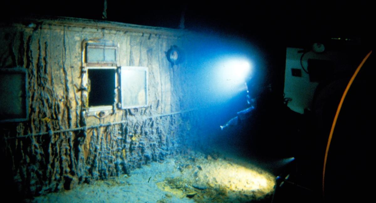 The researchers explore a deck bulkhead. (Courtesy of WHOI Archives /©Woods Hole Oceanographic Institution)