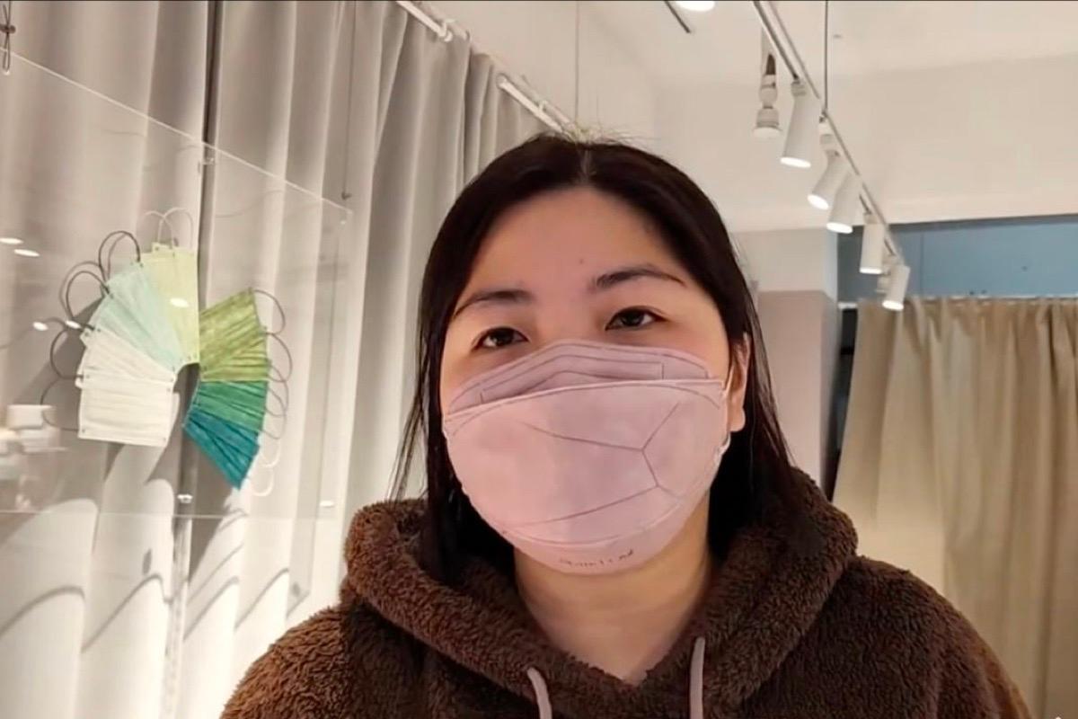 Ms. Lam, a sales assistant in a mask shop in Mong Kok, was interviewed yesterday. She said the new measures caught her off guard. (Screenshot from The Epoch Times video)