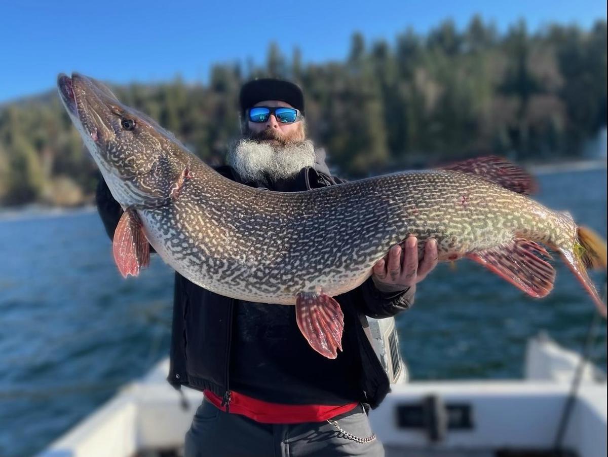 Thomas Francis holds up his record-breaking northern pike that claimed the Idaho state record after he battled the fish on Hayden Lake on March 21, 2023. (Courtesy of Thomas Francis via <a href="https://www.facebook.com/IdahoFishGame">Idaho Fish and Game</a>)