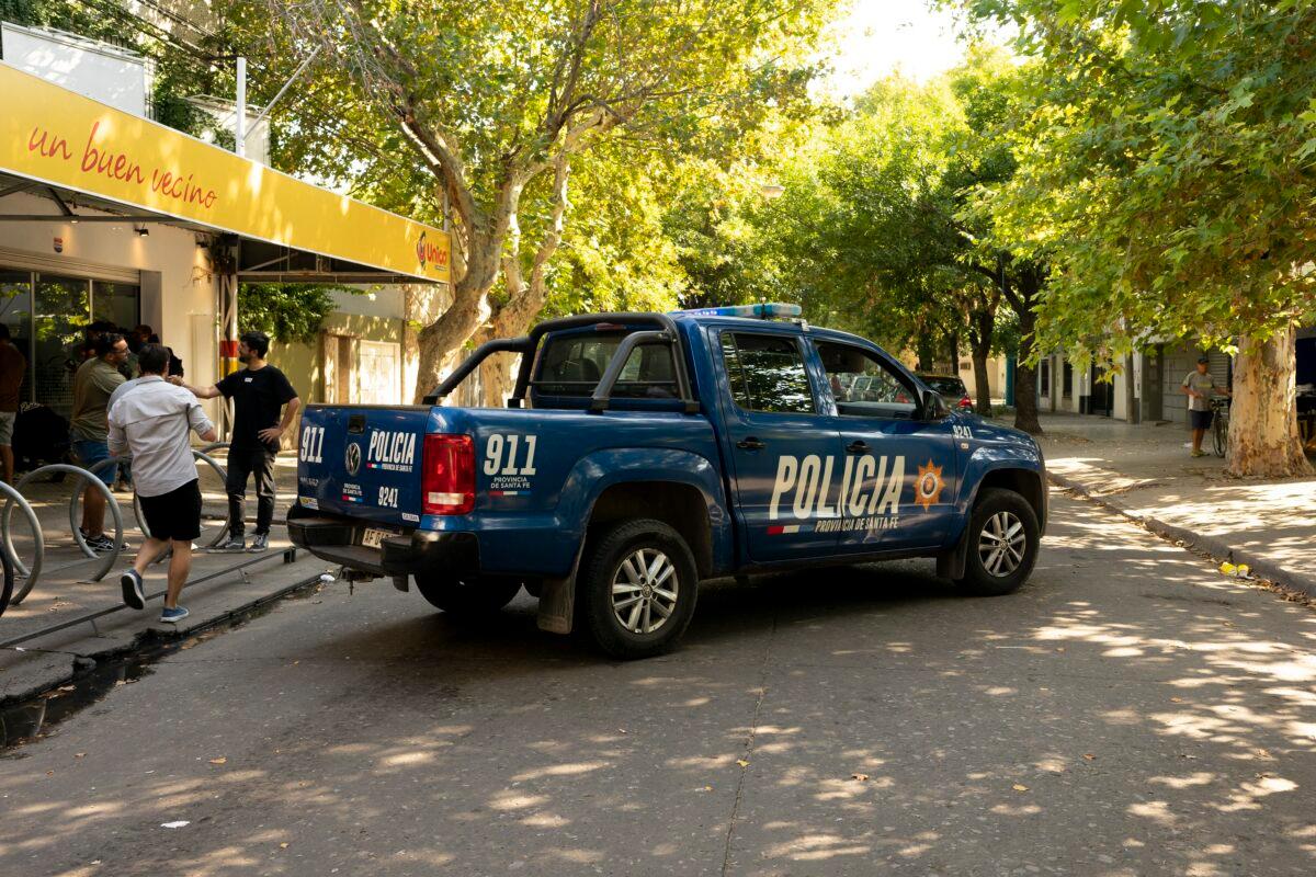 A police truck blocks the street outside the Unico supermarket, a grocery chain owned by soccer player Lionel Messi's in-laws, after it was shot at in Rosario, Argentina, on March 2, 2023. (Sebastian Lopez Brach/AP Photo)