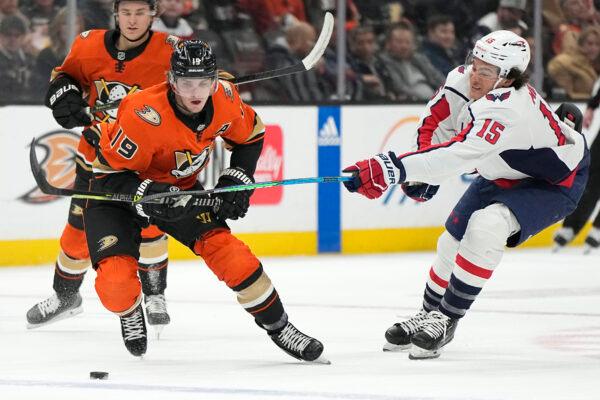 Anaheim Ducks right wing Troy Terry (19) moves the puck as Washington Capitals left wing Sonny Milano (15) reaches in during the first period of an NHL hockey game in Anaheim, Calif., on Mar. 1, 2023. (Mark J. Terrill/AP Photo)