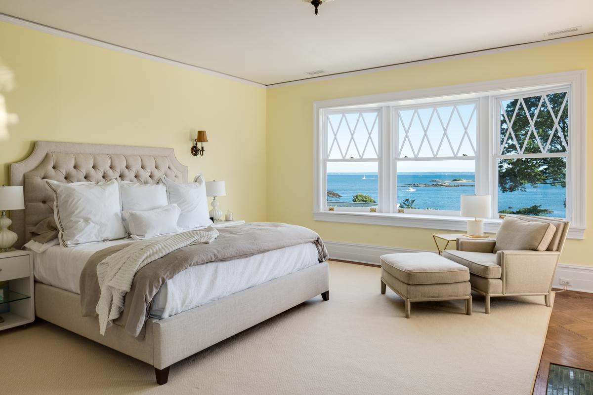 The occupants of this guest bedroom enjoy a breathtaking view of the grounds and the waters of Long Island Sound. (Daniel Milstein for Sotheby’s International Realty)