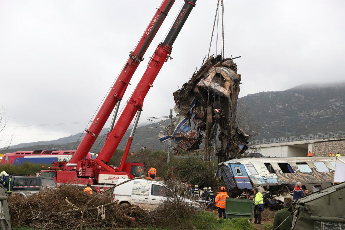 Cranes remove debris after a trains' collision in Tempe, about 376 kilometres (235 miles) north of Athens, near Larissa city, Greece, on March 2, 2023. (Vaggelis Kousioras/AP Photo)