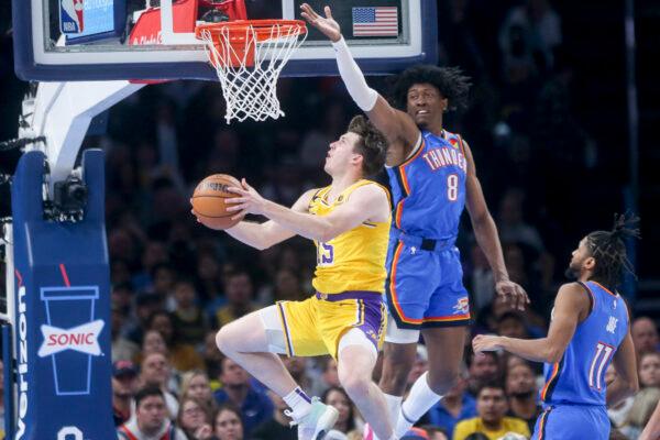 Austin Reaves (15) of the Los Angeles Lakers drives past Jalen Williams (8) of the Oklahoma City Thunder during the fourth quarter at Paycom Center in Oklahoma City on Mar. 1, 2023. (Ian Maule/Getty Images)
