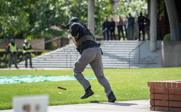 A mock shooter runs away from multiple law enforcement and first responder agencies participating in an active shooter exercise on the campus of Biola University in La Mirada, Calif., on Feb. 28, 2023. (John Fredricks/The Epoch Times)