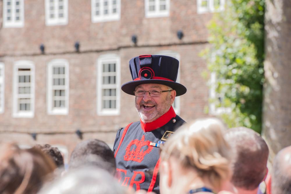 A Yeomen Warder of the Tower of London gives a historical talk to tourists. (Mark Anthony Ray/Shutterstock)