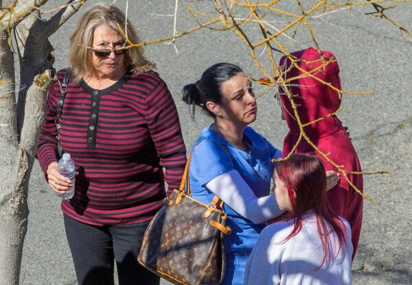 A hospital staff member consoles students while waiting outside Providence Santa Rosa Memorial Hospital after a student fight on the Montgomery High School campus resulted in one student being killed and another injured in Santa Rosa, Calif., on March 1, 2023.(Chad Surmick/The Press Democrat via AP)