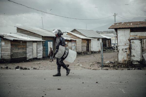 A Congolese policeman walks as he responds to protests in the Majengo neighborhood of Goma, Congo, on March 22, 2019, following four deaths and 10 kidnappings the previous night by unknown assailants. (Luke Dennison/AFP via Getty Images)