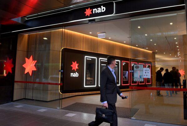 A man walks past a branch of the National Australia Bank (NAB) in Melbourne, Australia, on May 6, 2021. (William West/AFP via Getty Images)