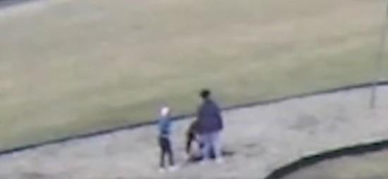 A screenshot from video released by the school district in Springfield, Ohio showing a third black student punching a white student in the head after charging them to the ground. (Springfield School District)
