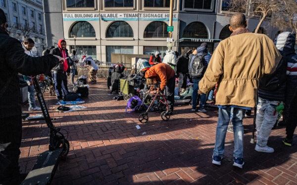 Homeless people gather near drug dealers in the Tenderloin District of San Francisco on Feb. 22, 2023. (John Fredricks/The Epoch Times)