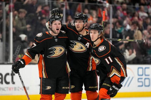 Anaheim Ducks center Mason McTavish, left, celebrates his goal with defenseman Cam Fowler, center, and center Trevor Zegras during the third period of an NHL hockey game against the Montreal Canadiens in Anaheim, Calif., on Mar. 3, 2023. (Mark J. Terrill/AP Photo)