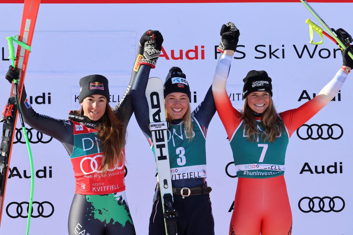 Norway's Kajsa Vickhoff Lie (C), winner of an alpine ski, World Cup women's downhill race, celebrates on the podium with second-placed Italy's Sofia Goggia (L), and third-placed Switzerland's Corinne Suter, in Kvitfjell, Norway, on March 4, 2023. (Marco Trovati/AP Photo)