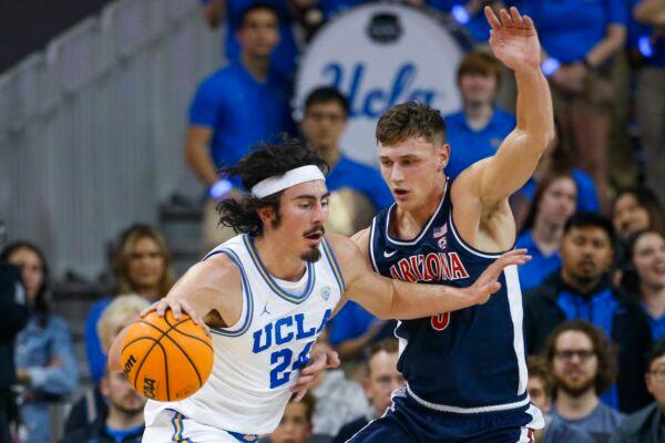 UCLA guard Jaime Jaquez Jr. (L) drives against Arizona guard Pelle Larsson during the first half of an NCAA college basketball game in Los Angeles on March 4, 2023. (Ringo H.W. Chiu/AP Photo)