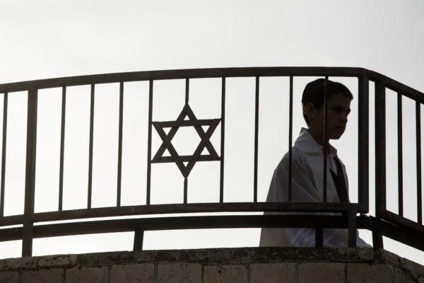 An Orthodox Jewish child stands on a synagogue roof near the scene of a mass shooting that took the lives of eight people near a synagogue in Jerusalem on Jan. 28, 2023. (Amir Levy/Getty Images)