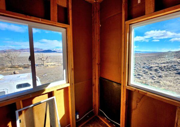 A view of the desert scape from the windows of survival housing under construction at Fortitude Ranch Nevada on March 2, 2023. (Allan Stein/The Epoch Times)