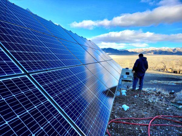 Brandon M, ranch manager at Fortitude Ranch Nevada, surveys the open range flanked by a solar panel on March 2, 2023. (Allan Stein/The Epoch Times)