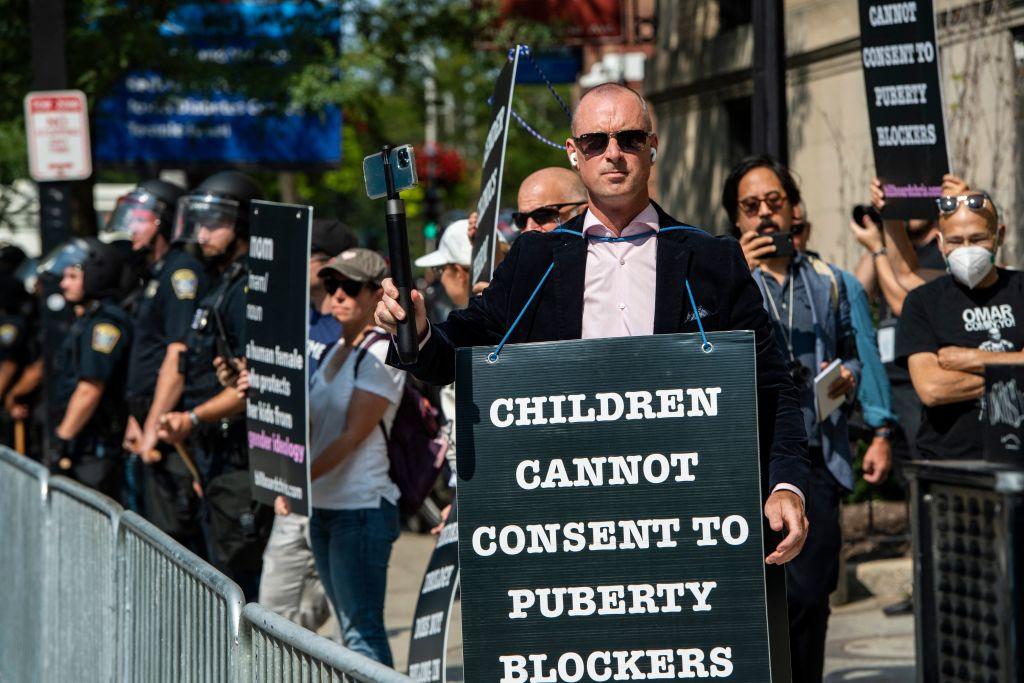 Anti-trans activist Chris Elston, joined by his supporters, demonstrates against "gender affirmation" treatments and surgeries on minors, outside of Boston Children's Hospital in Boston on Sept. 18, 2022. (Joseph Prezioso/AFP via Getty Images)