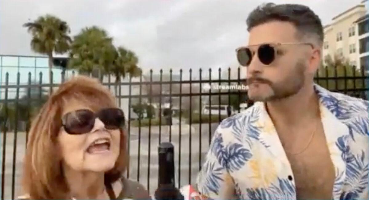 Jon Eugene Minadeo II, who leads an anti-Jewish group in Florida, conducts a video interview with a Jewish woman about potential Freedom of Speech infringement by a proposed Florida law outside of the Chabad of South Orlando on Feb. 22, 2023. (Screenshot courtesy of Joe Minadeo)