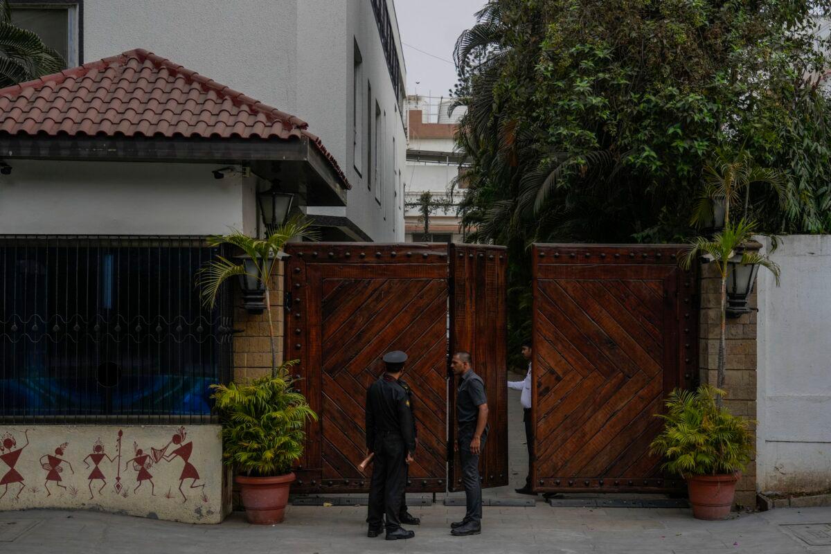 Security guards stand at the entrance of Bollywood superstar Amitabh Bachchan house in Mumbai, India, on March 6, 2023. (Rafiq Maqbool/AP Photo)