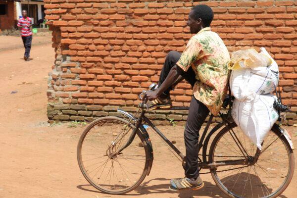 A man carries bags of fertilizer on his bicycle in Lilongwe, Malawi, on March 6, 2023. (Gregory Gondwe/AP Photo)